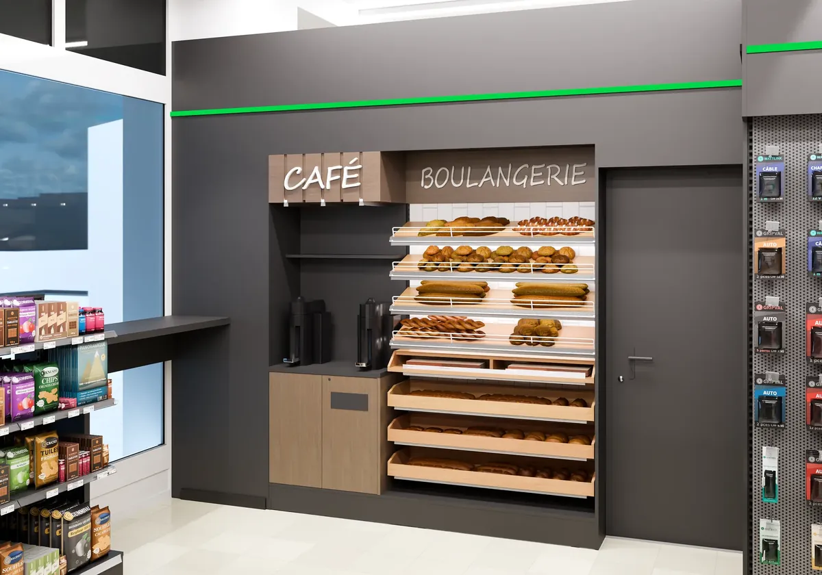 La niche café et boulangerie du shop : pains sur des grilles en bois, machines à café, porte de service.